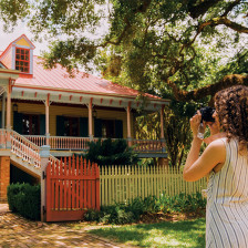 Visitor taking a photo of Laura Plantation in Vacherie, Louisiana